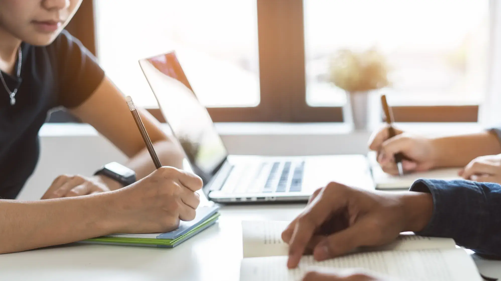 Three people sitting at a desk working