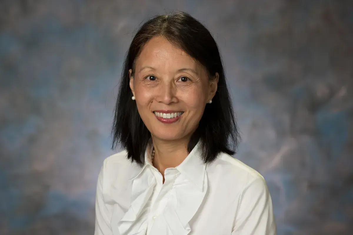 portrait of Jingzhen “Ginger” Yang in a white shirt