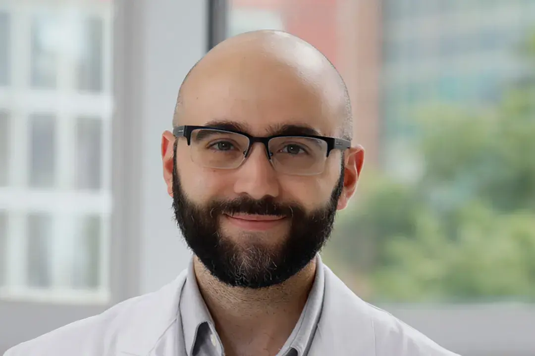 portrait of Mohamed Ridha wearing a white shirt and glasses