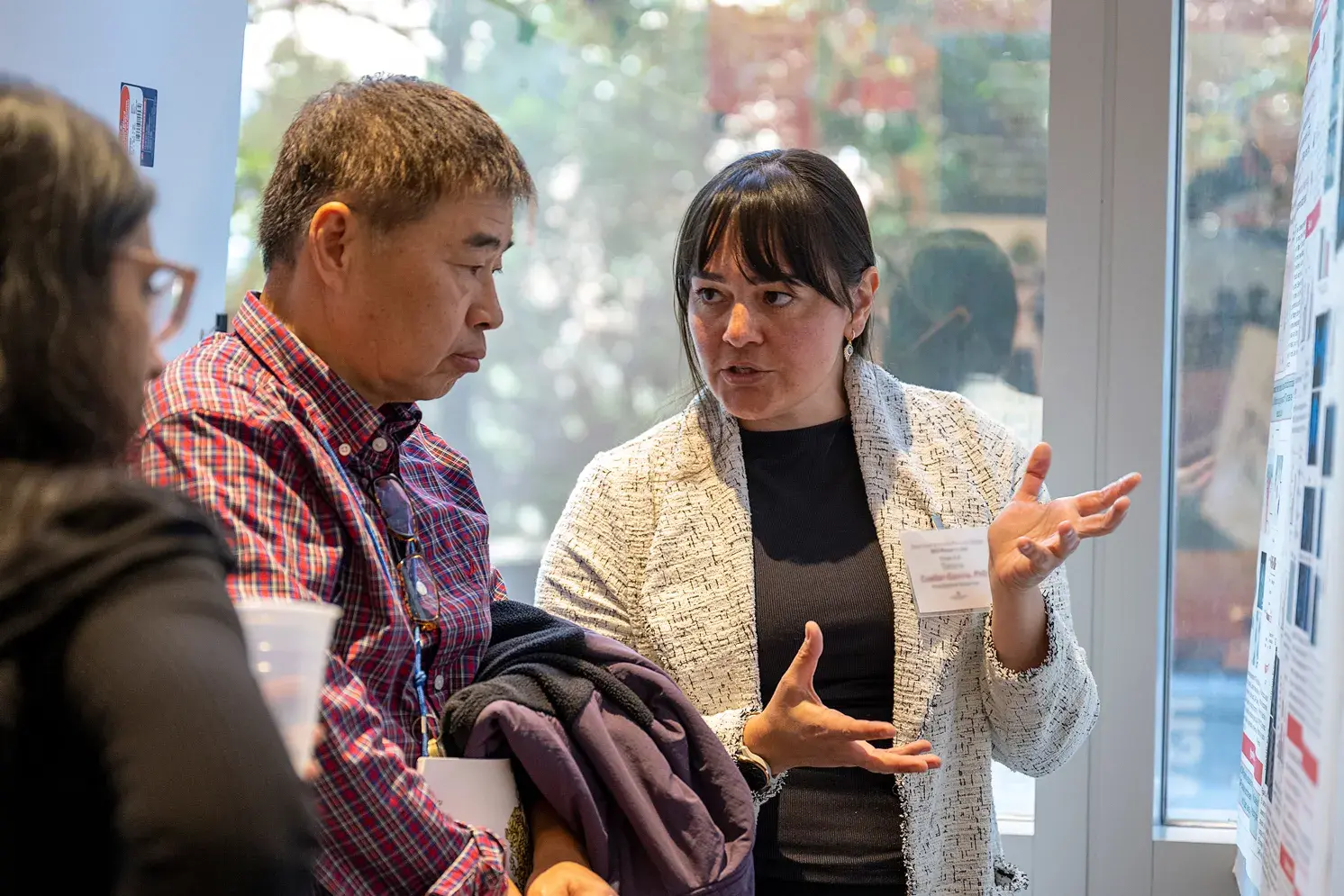 an ohio state researcher sharing documentation on a whiteboard with two people