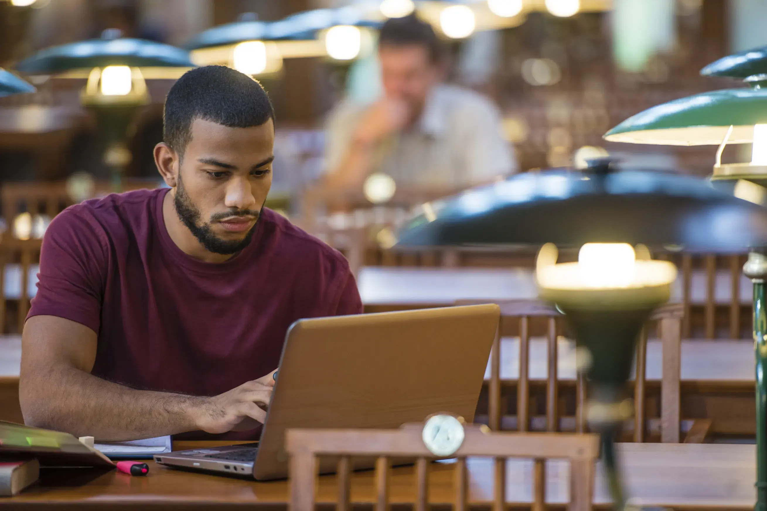 Man writing a grant on computer